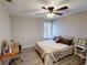 Well-lit bedroom with a ceiling fan, natural light, and a functional wooden desk at 4641 Devon Ave, Lakeland, FL 33813
