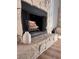 Close-up of a stone fireplace with mantle, hearth, and decorative accessories at 4641 Devon Ave, Lakeland, FL 33813