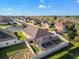 An aerial perspective reveals a fenced yard with a screened pool, set within a tranquil residential neighborhood at 474 Cedar Glen Dr, Lake Alfred, FL 33850