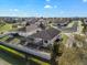 This aerial view showcases a fenced backyard, featuring a screened pool, against a serene neighborhood backdrop at 474 Cedar Glen Dr, Lake Alfred, FL 33850