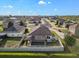 An aerial shot features a fenced-in backyard with a screened pool, complemented by well-maintained lawn at 474 Cedar Glen Dr, Lake Alfred, FL 33850