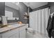 Stylish bathroom featuring dark gray walls, floating shelves, and a shower with a white curtain at 474 Cedar Glen Dr, Lake Alfred, FL 33850