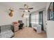 Cozy bedroom with neutral carpet, ceiling fan, and space for a home office setup at 474 Cedar Glen Dr, Lake Alfred, FL 33850