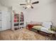 Inviting bedroom with soft carpet, a ceiling fan, and a decorative bookshelf, filled with light at 474 Cedar Glen Dr, Lake Alfred, FL 33850