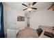 Comfortable carpeted bedroom offering natural light, ceiling fan, and ample space for personalization at 474 Cedar Glen Dr, Lake Alfred, FL 33850