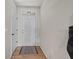 Bright foyer featuring wood-look floors, a white door, and natural light, creating a welcoming entry at 474 Cedar Glen Dr, Lake Alfred, FL 33850