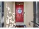 Elegant red front door with decorative wreath and modern hardware for a welcoming entrance at 474 Cedar Glen Dr, Lake Alfred, FL 33850