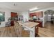 Well-lit kitchen features wood cabinets, an island with seating, and stainless steel appliances at 474 Cedar Glen Dr, Lake Alfred, FL 33850