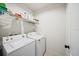 Functional laundry room equipped with washer, dryer, and overhead shelving at 474 Cedar Glen Dr, Lake Alfred, FL 33850