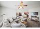 Spacious living room featuring a large sectional sofa, and views of the kitchen at 474 Cedar Glen Dr, Lake Alfred, FL 33850