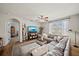 Open-concept living room features a sectional sofa and views of the exterior at 474 Cedar Glen Dr, Lake Alfred, FL 33850