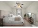 Relaxing main bedroom with soft carpet, a ceiling fan, and a TV for ultimate comfort at 474 Cedar Glen Dr, Lake Alfred, FL 33850