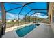 Sparkling screened-in pool with a beautiful blue sky view is ideal for relaxation and recreation at 474 Cedar Glen Dr, Lake Alfred, FL 33850