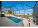 Screened-in pool area provides privacy and shade, perfect for relaxation and outdoor enjoyment at 474 Cedar Glen Dr, Lake Alfred, FL 33850