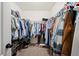 Walk-in closet with ample storage, multiple rows of hanging clothes, and shoe racks at 474 Cedar Glen Dr, Lake Alfred, FL 33850
