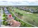 Aerial view of property backing onto a golf course with community views at 565 Osprey Landing Dr, Lakeland, FL 33813