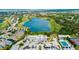 An aerial view of a lakeside community with a golf course, swimming pool, and tennis courts at 565 Osprey Landing Dr, Lakeland, FL 33813