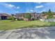 Charming backyard with a screened-in patio, lush landscaping, and a white picket fence at 565 Osprey Landing Dr, Lakeland, FL 33813