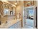 Bathroom with double sinks, decorative mirrors, and view to the bedroom at 565 Osprey Landing Dr, Lakeland, FL 33813
