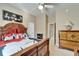 Bedroom with a dark wood bedframe, beige walls and carpet, and Asian-themed decor at 565 Osprey Landing Dr, Lakeland, FL 33813