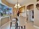 Cozy breakfast nook featuring a chandelier and expansive views of the golf course and landscaping at 565 Osprey Landing Dr, Lakeland, FL 33813