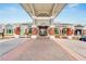 Inviting clubhouse entrance with brick columns, elegant signage, and well-maintained landscaping and red brick driveway at 565 Osprey Landing Dr, Lakeland, FL 33813