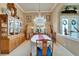 Well appointed dining room with chandelier, buffet and two large decorative vases either side of window at 565 Osprey Landing Dr, Lakeland, FL 33813