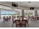Bright dining room showcasing tables, chairs, and a scenic view of the lake and golf course at 565 Osprey Landing Dr, Lakeland, FL 33813