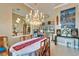 Elegant dining room open to the living area with an ornate chandelier, decor, and a bright, open layout at 565 Osprey Landing Dr, Lakeland, FL 33813