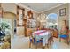 Refined dining room with a large chandelier, ornate buffet, and plenty of natural light from a large window at 565 Osprey Landing Dr, Lakeland, FL 33813
