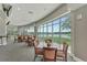 The dining room offers scenic views of the lake and golf course through large windows with ample seating at 565 Osprey Landing Dr, Lakeland, FL 33813
