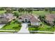 Stunning aerial view of a well-manicured home with a lush green lawn and mature landscaping at 565 Osprey Landing Dr, Lakeland, FL 33813