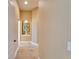 Bright hallway featuring light wood floors, neutral paint, and an art niche with decorative items at 565 Osprey Landing Dr, Lakeland, FL 33813