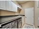 Laundry room with white cabinets, dark countertops, and washer and dryer at 565 Osprey Landing Dr, Lakeland, FL 33813