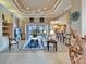 Spacious living room features a tray ceiling, access to the pool area, and an open floor plan at 565 Osprey Landing Dr, Lakeland, FL 33813