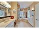 Bright main bathroom with double vanity, soaking tub, glass shower, and tile floors at 565 Osprey Landing Dr, Lakeland, FL 33813