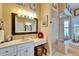 A beautiful main bathroom features double vanities, a glass shower, and a luxurious soaking tub at 565 Osprey Landing Dr, Lakeland, FL 33813