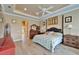 Large main bedroom featuring trey ceiling, wood floors, neutral colors, and ensuite bathroom at 565 Osprey Landing Dr, Lakeland, FL 33813