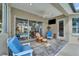 Inviting covered patio with comfortable seating and a mounted television, perfect for outdoor relaxation and entertainment at 565 Osprey Landing Dr, Lakeland, FL 33813