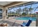 Outdoor pool with a screened enclosure and a view to the golf course at 565 Osprey Landing Dr, Lakeland, FL 33813