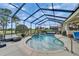 Stunning screened-in pool with a lush green golf course view, offering a private outdoor retreat at 565 Osprey Landing Dr, Lakeland, FL 33813