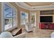 A sitting area in the main bedroom with wood floors, plantation shutters, and a pool view at 565 Osprey Landing Dr, Lakeland, FL 33813