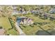 Aerial view of the home and property including the driveway and the well manicured and landscaped lawn at 5676 Case Ln, Lakeland, FL 33813