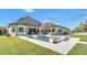 Sprawling backyard features a large pool with sun shelves, a spa, outdoor living spaces, and covered outdoor kitchen at 5676 Case Ln, Lakeland, FL 33813
