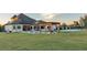 Backyard view featuring a custom pool, covered outdoor living, pergola, sport court, and manicured green lawns at 5676 Case Ln, Lakeland, FL 33813