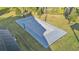 Aerial view of a basketball court showcasing the gray playing surface and neatly trimmed green grass surroundings at 5676 Case Ln, Lakeland, FL 33813