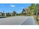 Outdoor basketball court featuring a professional hoop, gray playing surface, and white boundary lines on a sunny day at 5676 Case Ln, Lakeland, FL 33813