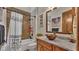 Bathroom featuring patterned tile, granite counters, and bronze fixtures at 5676 Case Ln, Lakeland, FL 33813