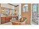 A luxury bathroom includes a standalone copper tub, walk-in shower, and elegant vanity with stone countertops at 5676 Case Ln, Lakeland, FL 33813