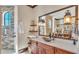 Elegant bathroom vanity featuring stone counters, decorative lighting, and convenient open shelving and drawers at 5676 Case Ln, Lakeland, FL 33813